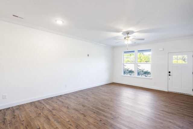 empty room with dark hardwood / wood-style floors, ceiling fan, and crown molding