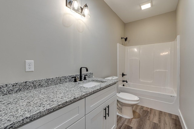 full bathroom with hardwood / wood-style flooring, vanity, shower / bathing tub combination, and toilet