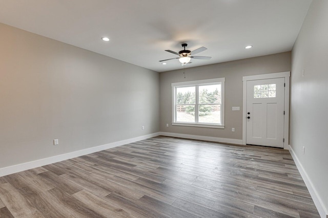 foyer entrance featuring ceiling fan and light wood-type flooring