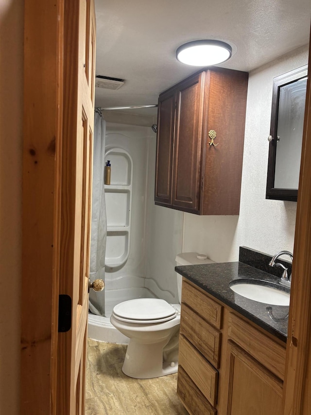 2025 County Road 750, Calhoun, TN 37309 - full bath featuring vanity, a stall shower, toilet, and wood finished floors