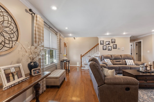 living room with crown molding and light hardwood / wood-style flooring