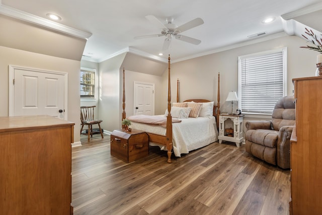 bedroom with crown molding, ceiling fan, and dark hardwood / wood-style flooring