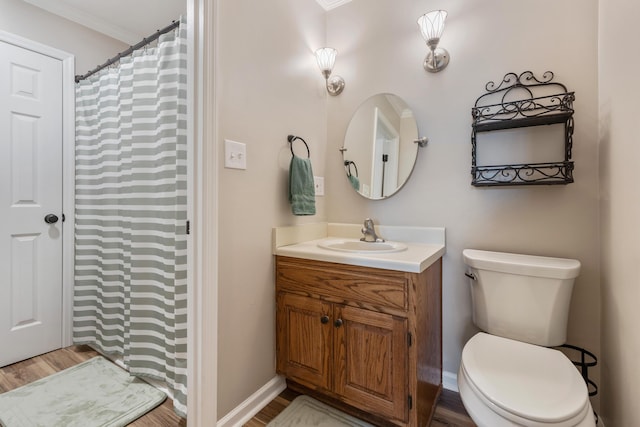 bathroom with vanity, toilet, and hardwood / wood-style floors