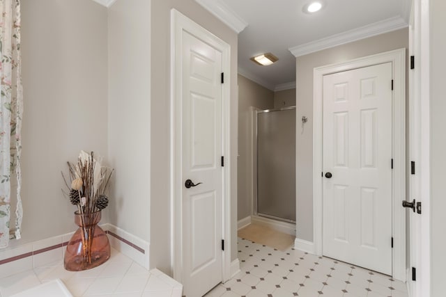 bathroom featuring ornamental molding and an enclosed shower