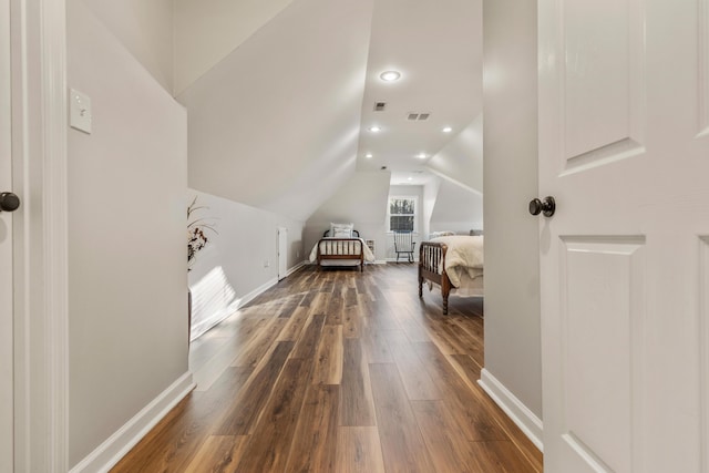 bedroom featuring hardwood / wood-style flooring and lofted ceiling