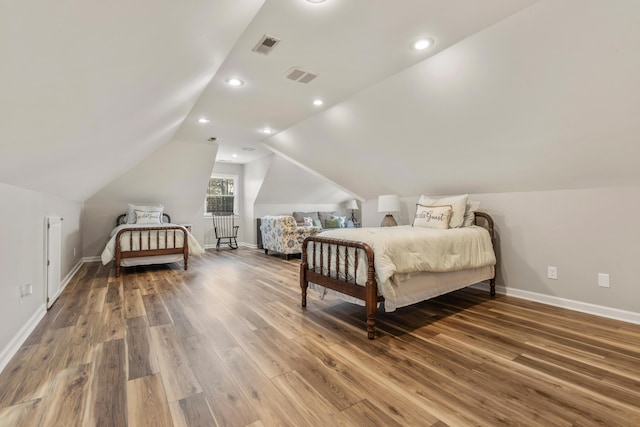 bedroom with lofted ceiling and hardwood / wood-style floors