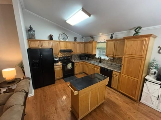 kitchen featuring backsplash, lofted ceiling, ornamental molding, and black appliances