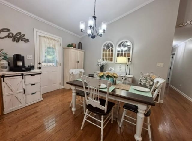 dining room with baseboards, an inviting chandelier, ornamental molding, and wood finished floors
