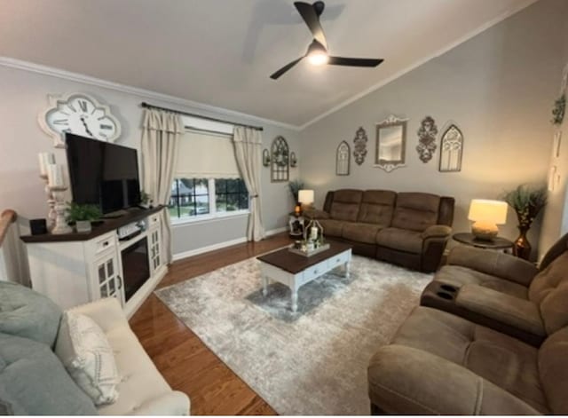 living area featuring a ceiling fan, crown molding, wood finished floors, baseboards, and lofted ceiling