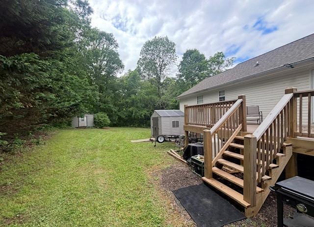 view of yard with a storage unit, a wooden deck, an outdoor structure, and stairway