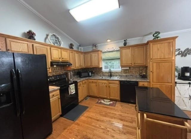 kitchen with crown molding, under cabinet range hood, a sink, backsplash, and black appliances