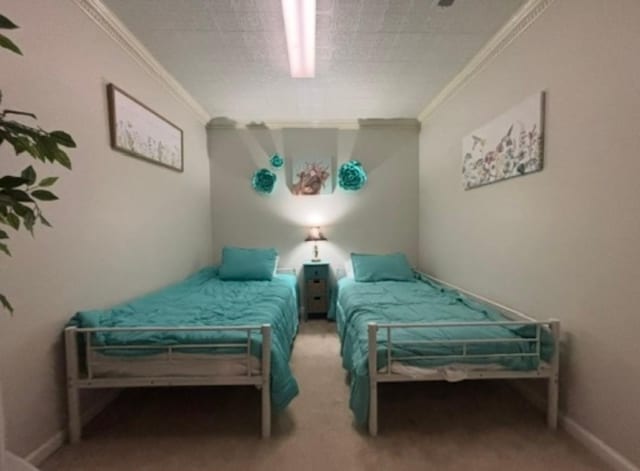 bedroom with carpet floors and ornamental molding