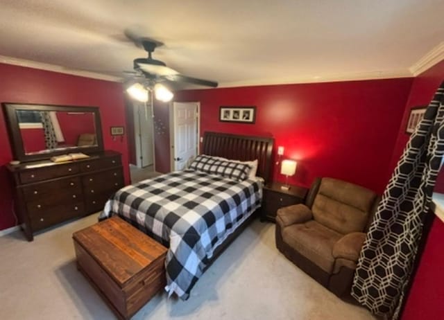 bedroom featuring crown molding, a ceiling fan, and carpet