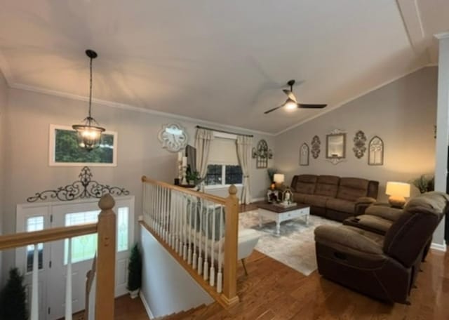 living room featuring wood finished floors, crown molding, ceiling fan, and lofted ceiling