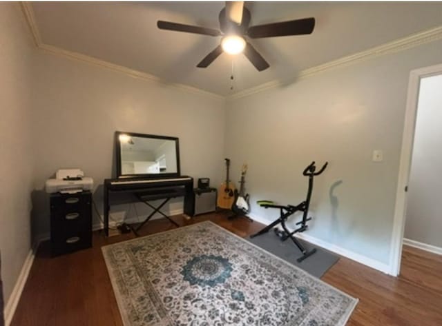 interior space with baseboards, a ceiling fan, dark wood finished floors, and crown molding