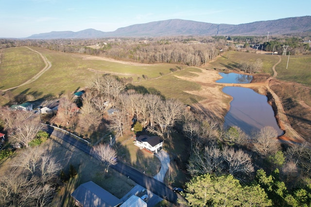 drone / aerial view featuring a water and mountain view