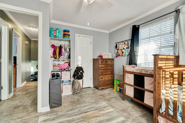 bedroom featuring ceiling fan, baseboards, and crown molding