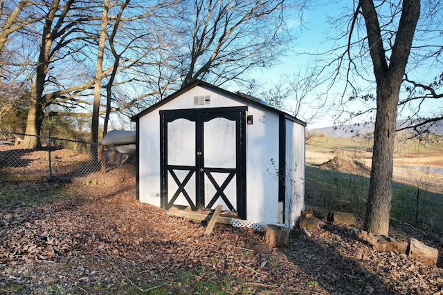 view of shed with fence