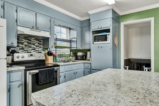 kitchen featuring light countertops, white microwave, stainless steel range with electric cooktop, a sink, and under cabinet range hood