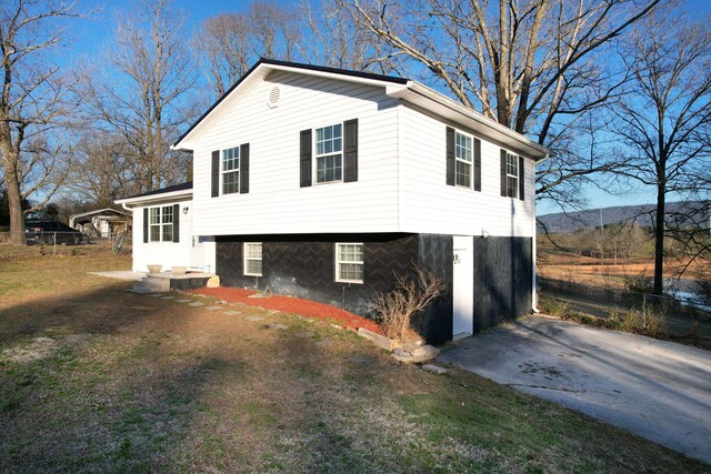 view of property exterior featuring fence and aphalt driveway