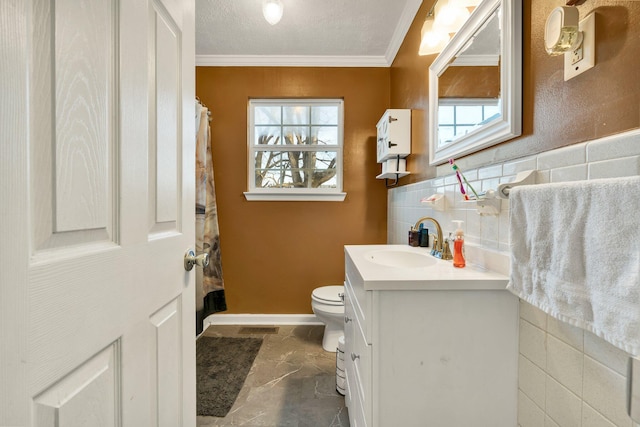 bathroom featuring a textured ceiling, vanity, a wealth of natural light, and crown molding