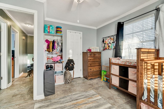 bedroom with ceiling fan, baseboards, and crown molding