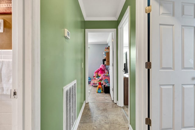 corridor featuring visible vents, crown molding, and baseboards