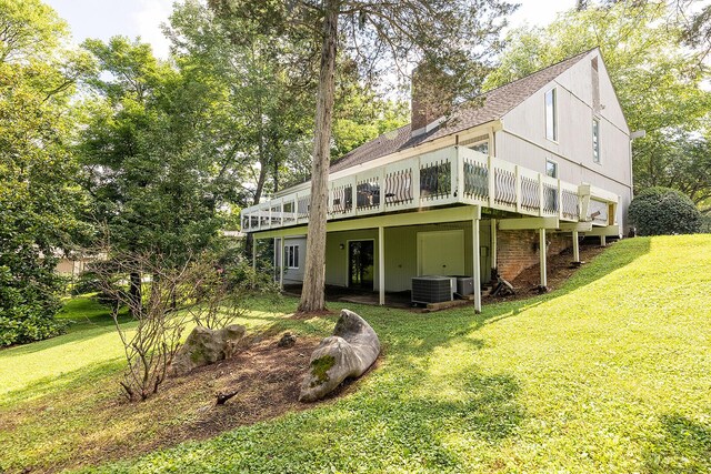 604 Augusta National Way, Knoxville, TN 37934 - back of property featuring a lawn, a deck, a shingled roof, and a chimney