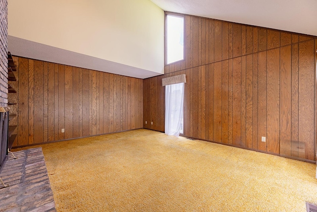 604 Augusta National Way, Knoxville, TN 37934 - unfurnished living room featuring healthy amount of natural light, wood walls, and carpet