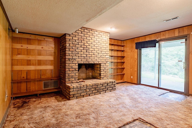 604 Augusta National Way, Knoxville, TN 37934 - unfurnished living room with wood walls, carpet, a textured ceiling, a fireplace, and built in features