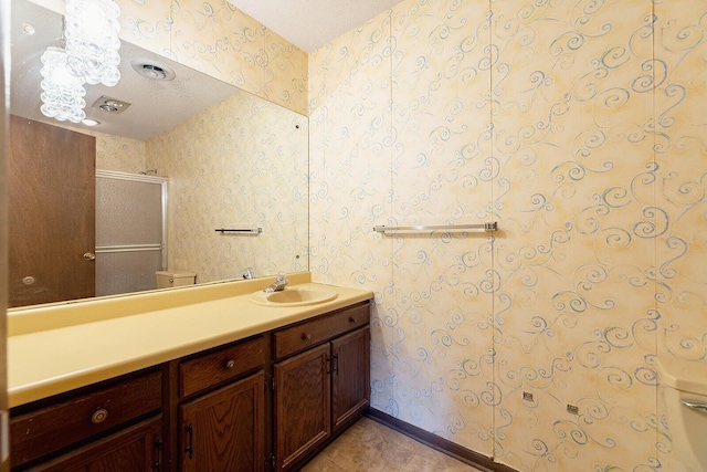 604 Augusta National Way, Knoxville, TN 37934 - bathroom featuring wallpapered walls, vanity, and a stall shower