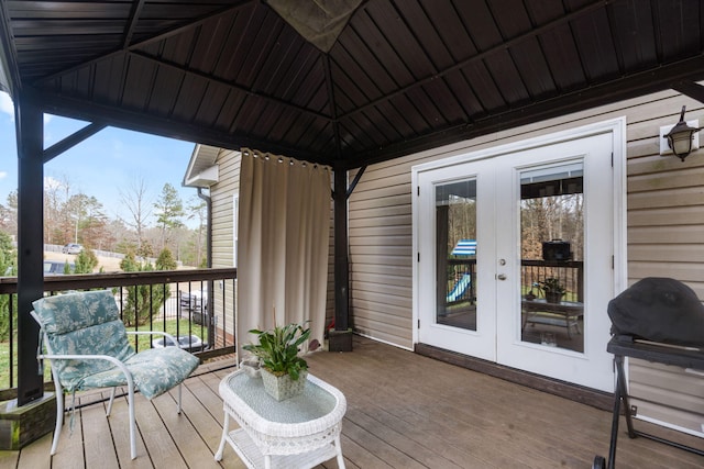 wooden deck featuring french doors, a gazebo, and grilling area