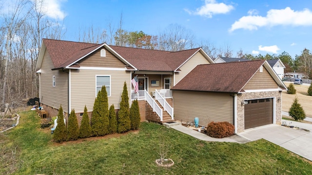 view of front of home featuring covered porch, a front yard, and a garage