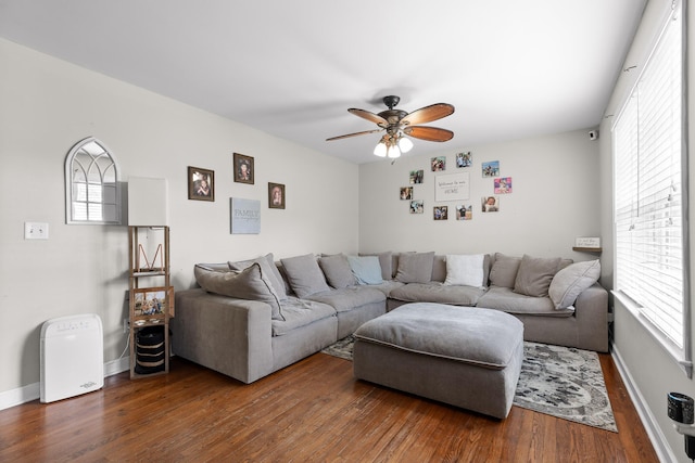 living room with dark hardwood / wood-style floors and ceiling fan