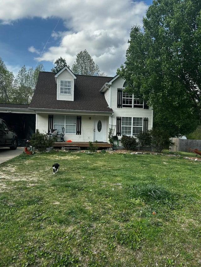view of front facade with fence, a garage, a front lawn, roof with shingles, and a porch