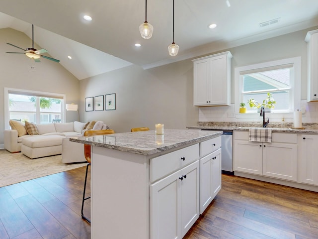 1105 18th St NW, Cleveland, TN 37311 - kitchen featuring open floor plan, a center island, wood finished floors, ceiling fan, and a kitchen bar