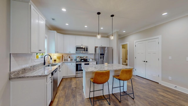 1105 18th St NW, Cleveland, TN 37311 - kitchen with stainless steel appliances, a sink, a center island, dark wood-style floors, and backsplash