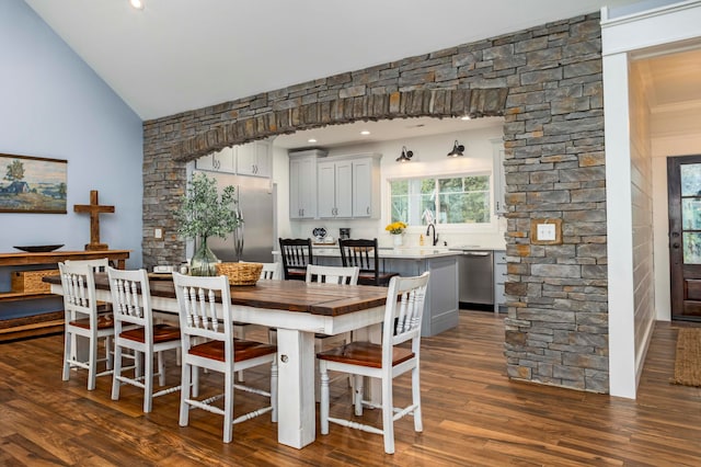 dining room featuring dark hardwood / wood-style flooring and lofted ceiling