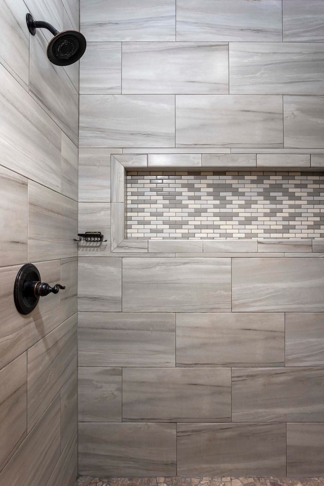 bathroom with tiled shower