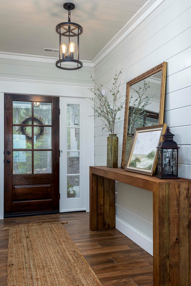 foyer featuring dark hardwood / wood-style flooring and ornamental molding