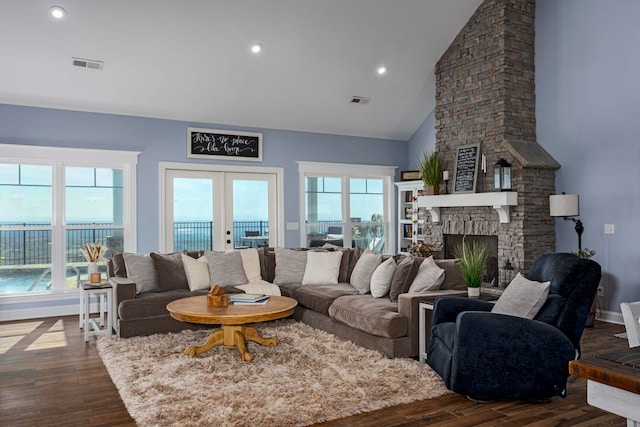 living room featuring a fireplace, french doors, high vaulted ceiling, and dark wood-type flooring