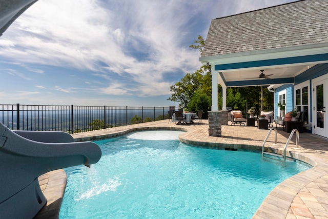 view of swimming pool featuring french doors, outdoor lounge area, ceiling fan, a patio area, and a water slide