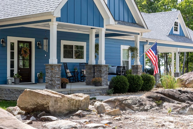 view of exterior entry with covered porch