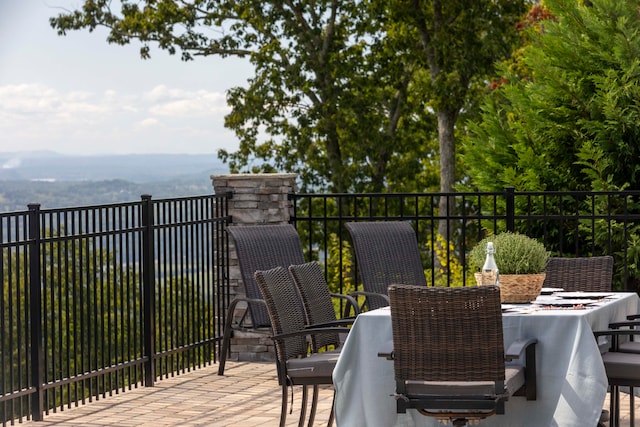 wooden terrace with a patio area