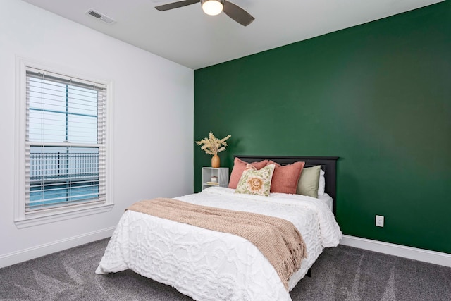 bedroom featuring dark colored carpet and ceiling fan