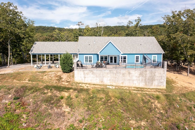 rear view of property featuring a lawn and a patio