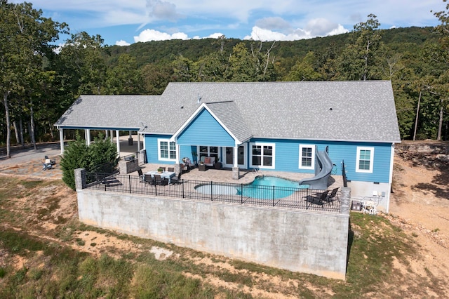 rear view of house with an outdoor living space and a patio