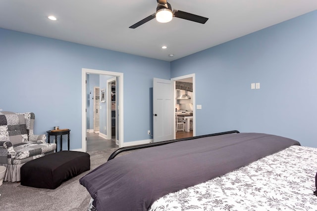 carpeted bedroom with a spacious closet and ceiling fan