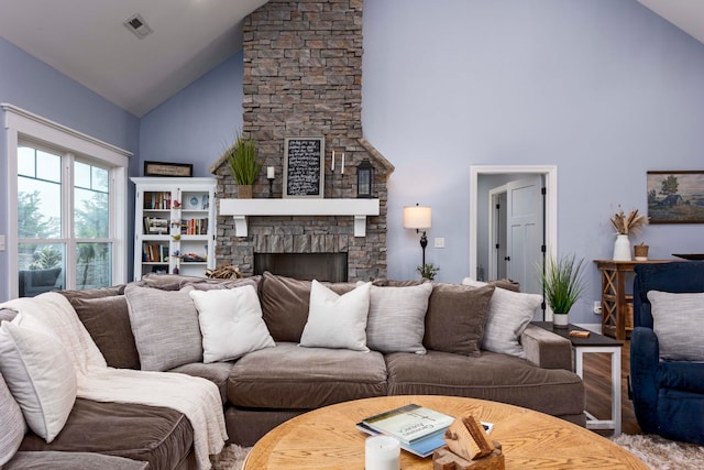 living room with a fireplace, high vaulted ceiling, and wood-type flooring