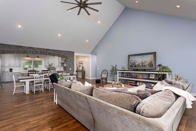 living room with ceiling fan, dark hardwood / wood-style flooring, and high vaulted ceiling